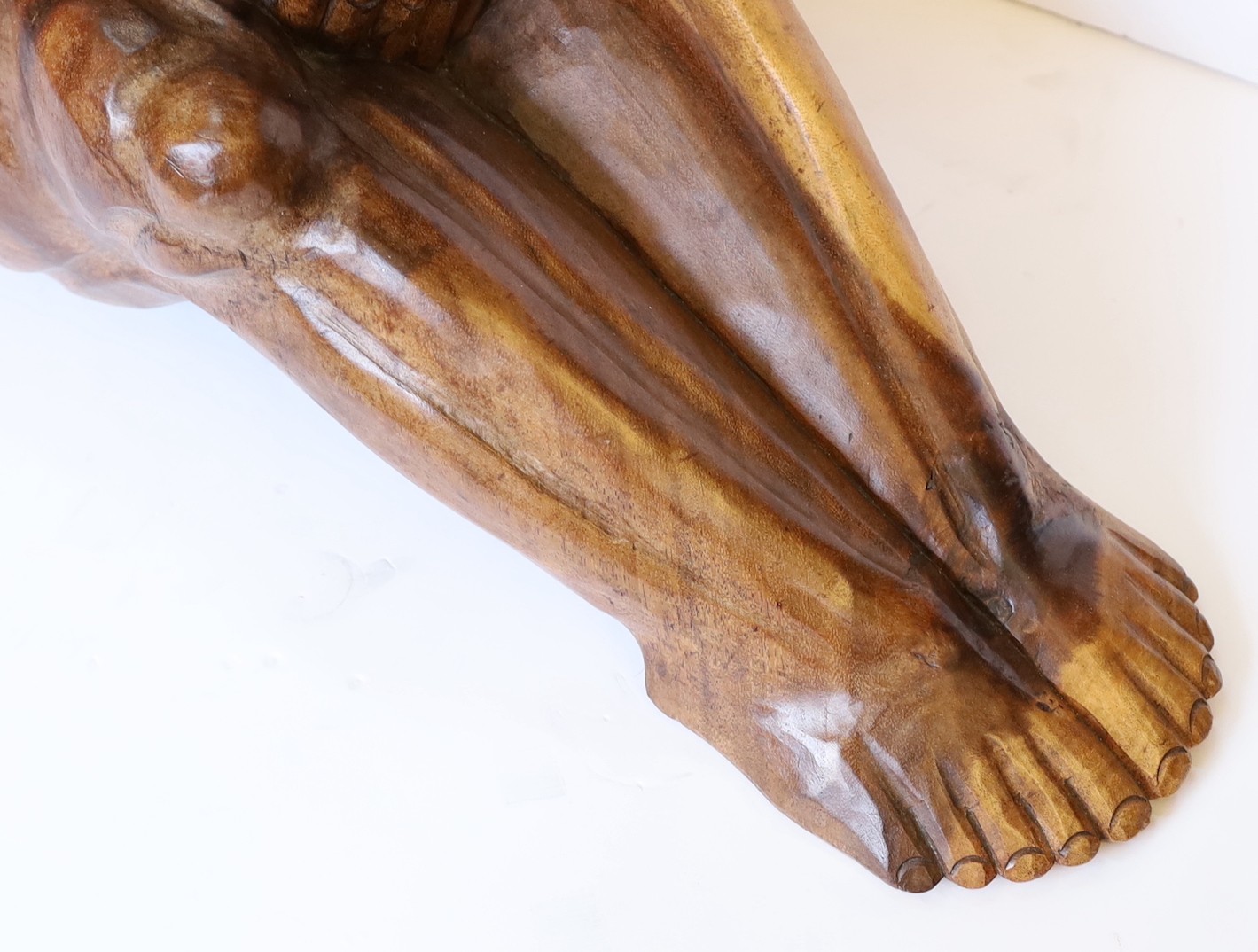 A Malaysian carved hardwood figure of the weeping Buddha, length 60cm. height 26cm